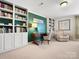Home office with built-in bookshelves, a desk, chair and accent chair at 1874 Larkspur Way, Tega Cay, SC 29708