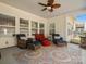 Cozy screened-in porch featuring comfortable wicker furniture and a patterned outdoor rug at 1874 Larkspur Way, Tega Cay, SC 29708