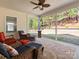 View of the cozy screened-in porch featuring comfortable furniture and a ceiling fan at 1874 Larkspur Way, Tega Cay, SC 29708