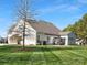 The house features a well-manicured lawn, a patio area, and mature trees offering shade and privacy at 2020 Holly Villa Cir, Indian Trail, NC 28079