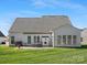 View of the rear exterior featuring a patio, awning, and multiple windows providing ample natural light at 2020 Holly Villa Cir, Indian Trail, NC 28079