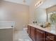 Well-maintained bathroom with double vanity, soaking tub, and neutral decor at 2020 Holly Villa Cir, Indian Trail, NC 28079