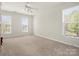 A serene bedroom with ample natural light, two large windows, and neutral carpet flooring at 2020 Holly Villa Cir, Indian Trail, NC 28079