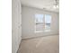 A large bedroom with neutral carpet flooring, ceiling fan, two large windows and fresh, white paint at 2020 Holly Villa Cir, Indian Trail, NC 28079