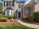 Inviting brick home featuring a bay window and landscaped walkway leading to the front door at 2020 Holly Villa Cir, Indian Trail, NC 28079