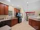 Functional kitchen with warm wood cabinetry and a view into the breakfast nook at 2020 Holly Villa Cir, Indian Trail, NC 28079
