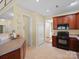 A kitchen featuring wood cabinets, a black range, and tile floors at 2020 Holly Villa Cir, Indian Trail, NC 28079