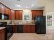 Well-equipped kitchen featuring dark wood cabinets and modern appliances at 2020 Holly Villa Cir, Indian Trail, NC 28079
