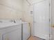 Laundry room equipped with a side-by-side washer and dryer set up and wire rack shelving above for storage at 2020 Holly Villa Cir, Indian Trail, NC 28079
