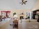 Open-concept living room featuring a fireplace, neutral colors, and abundant natural light at 2020 Holly Villa Cir, Indian Trail, NC 28079