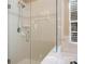 A large glass-enclosed tiled shower is featured with a shower head, handle and soap holder for convenience at 2020 Holly Villa Cir, Indian Trail, NC 28079