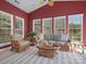 A sun room featuring multiple windows and casual wicker furniture at 2020 Holly Villa Cir, Indian Trail, NC 28079
