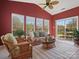 A sun room with casual wicker furniture, many windows, and a sliding glass door at 2020 Holly Villa Cir, Indian Trail, NC 28079
