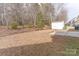 Spacious backyard features a storage shed, trees, and a concrete pad at 212 Mary Caroline Springs Dr, Mount Holly, NC 28120