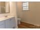 This bathroom has a toilet, sink with a faucet, and a large mirror at 212 Mary Caroline Springs Dr, Mount Holly, NC 28120