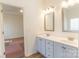 Bright bathroom with double sinks and a view into the bedroom at 212 Mary Caroline Springs Dr, Mount Holly, NC 28120