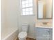 Bathroom features a bathtub, toilet, vanity with mirror and lighting at 212 Mary Caroline Springs Dr, Mount Holly, NC 28120