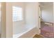A large tub and glass block window are features of this bright and spacious bathroom at 212 Mary Caroline Springs Dr, Mount Holly, NC 28120