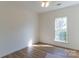 Bright bedroom features hardwood floors, a ceiling fan, and a window letting in natural light at 212 Mary Caroline Springs Dr, Mount Holly, NC 28120