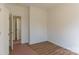 A spacious bedroom with a doorway leading to an ensuite bathroom provides ample living space at 212 Mary Caroline Springs Dr, Mount Holly, NC 28120