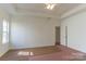 Large main bedroom boasts a tray ceiling, a window, and doorway at 212 Mary Caroline Springs Dr, Mount Holly, NC 28120