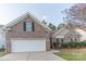 Charming brick home with a two-car garage and well-maintained landscaping at 212 Mary Caroline Springs Dr, Mount Holly, NC 28120