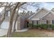 Charming brick home with a well-manicured lawn and dark shutters, complemented by mature trees and a two car garage at 212 Mary Caroline Springs Dr, Mount Holly, NC 28120