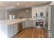 Modern kitchen featuring stainless steel appliances, white cabinets, quartz countertops, and wood-look flooring at 212 Mary Caroline Springs Dr, Mount Holly, NC 28120