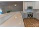 Kitchen featuring stainless steel appliances, white cabinets, quartz countertops, and wood-look flooring at 212 Mary Caroline Springs Dr, Mount Holly, NC 28120