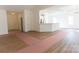 Open-concept living room boasts wood flooring, natural light, and seamless flow into the modern kitchen at 212 Mary Caroline Springs Dr, Mount Holly, NC 28120
