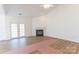 Bright living room with fireplace and French doors to let in natural light, and a ceiling fan at 212 Mary Caroline Springs Dr, Mount Holly, NC 28120