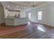 Open floor plan integrating kitchen, living room, and dining area, featuring modern finishes and flooring at 212 Mary Caroline Springs Dr, Mount Holly, NC 28120