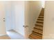 Staircase leading upstairs with wood flooring and white risers, bathed in natural light at 212 Mary Caroline Springs Dr, Mount Holly, NC 28120
