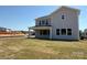 Backyard with covered patio and a gray siding, under a bright blue sky at 2204 Camber Dr # Cwo0076, Gastonia, NC 28054