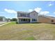 Spacious backyard with ample lawn space, covered patio, and neighboring house at 2204 Camber Dr # Cwo0076, Gastonia, NC 28054