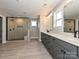 Elegant bathroom featuring dual sink vanity and frameless glass walk-in shower with bench at 2204 Camber Dr # Cwo0076, Gastonia, NC 28054
