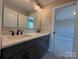 Dual sink bathroom with large mirror and contrasting cabinets, provides excellent storage at 2204 Camber Dr # Cwo0076, Gastonia, NC 28054