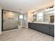 Elegant bathroom featuring dual sink vanity and frameless glass walk-in shower with bench at 2204 Camber Dr # Cwo0076, Gastonia, NC 28054