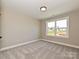 Neutrally decorated bedroom featuring plush carpeting and large window at 2204 Camber Dr # Cwo0076, Gastonia, NC 28054