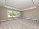 Bright, neutral bedroom with large window, tray ceiling and plush carpet at 2204 Camber Dr # Cwo0076, Gastonia, NC 28054