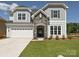 Charming two-story home features a stone entryway, attached two-car garage, and manicured lawn at 2204 Camber Dr # Cwo0076, Gastonia, NC 28054