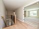 Bright hallway featuring hardwood floors, a staircase, and an open doorway at 2204 Camber Dr # Cwo0076, Gastonia, NC 28054