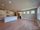 Open kitchen with white cabinets, island, and stainless steel appliances at 2204 Camber Dr # Cwo0076, Gastonia, NC 28054