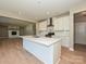 Beautiful kitchen with quartz countertops, a white backsplash, stainless steel appliances, and hardwood flooring at 2204 Camber Dr # Cwo0076, Gastonia, NC 28054