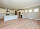 Open kitchen and living area featuring white cabinets, an island, and natural lighting at 2204 Camber Dr # Cwo0076, Gastonia, NC 28054