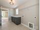Functional laundry room with modern cabinets and a wire shelf, featuring tile floors at 2204 Camber Dr # Cwo0076, Gastonia, NC 28054