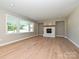 Open-concept living room with hardwood flooring, fireplace, recessed lighting, and large windows at 2204 Camber Dr # Cwo0076, Gastonia, NC 28054