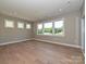 Bright room with large windows offering a view of the landscaped yard and hardwood flooring at 2204 Camber Dr # Cwo0076, Gastonia, NC 28054