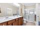 Well-lit bathroom with double vanity, ample counter space, and a glass-enclosed shower at 3008 Sweetleaf Dr, Fort Mill, SC 29707