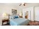 Bright bedroom with hardwood floors, neutral walls, and a peek into an ensuite bathroom at 3008 Sweetleaf Dr, Fort Mill, SC 29707
